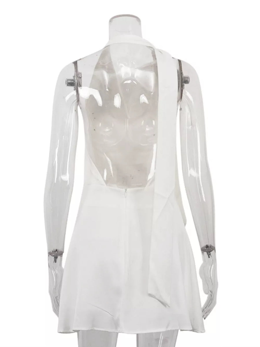 White halter neck mini dress with a low back and tie detail.