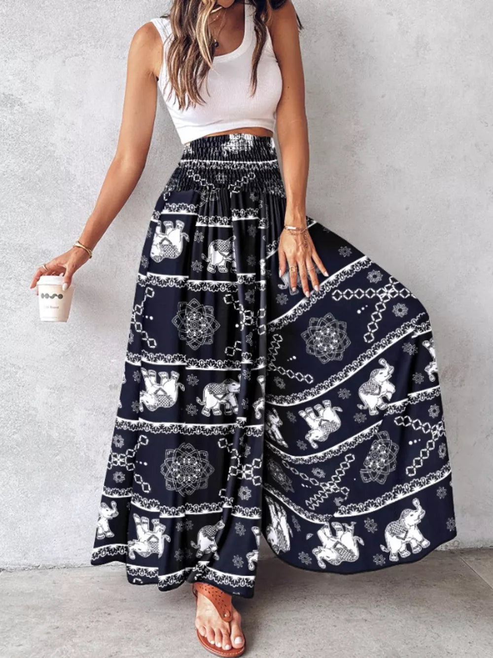Bohemian print smocked waist wide-leg pants in dark navy with elephant pattern.
