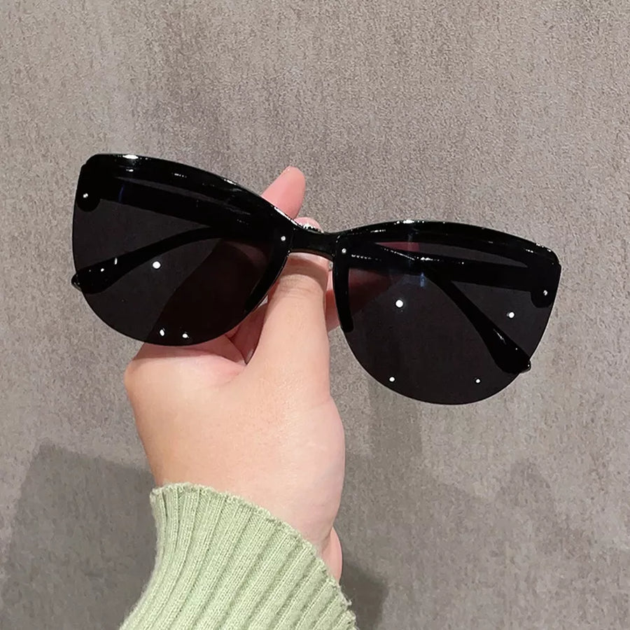 sunglasses in black featuring UV protection and cat-eye fit