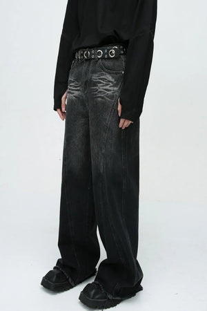 Faded panel wide-leg dark wash jeans with a distressed pattern and raw hem.