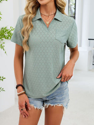 Sage eyelet polo collar blouse with short sleeves and a chest pocket.