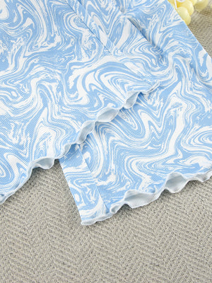 Lace-up loungewear set in blue and white marble print with lettuce trim details.