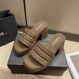 Padded platform mules in mocha with a block heel and square toe.