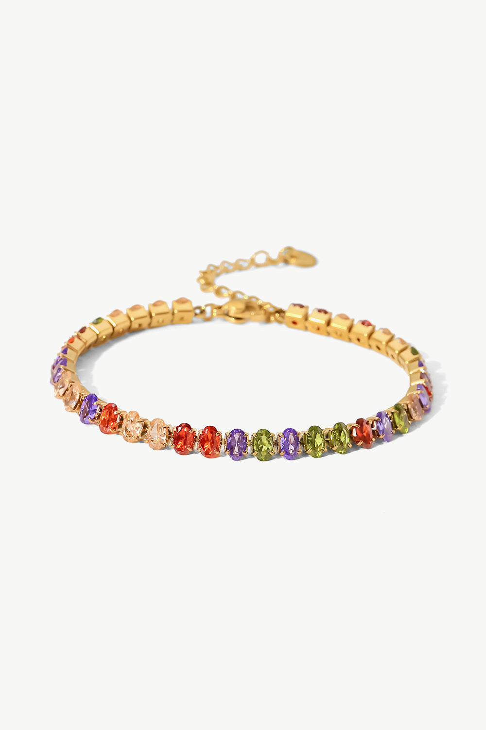 18K gold plated tennis bracelet with multi-colored oval cubic zirconia stones.