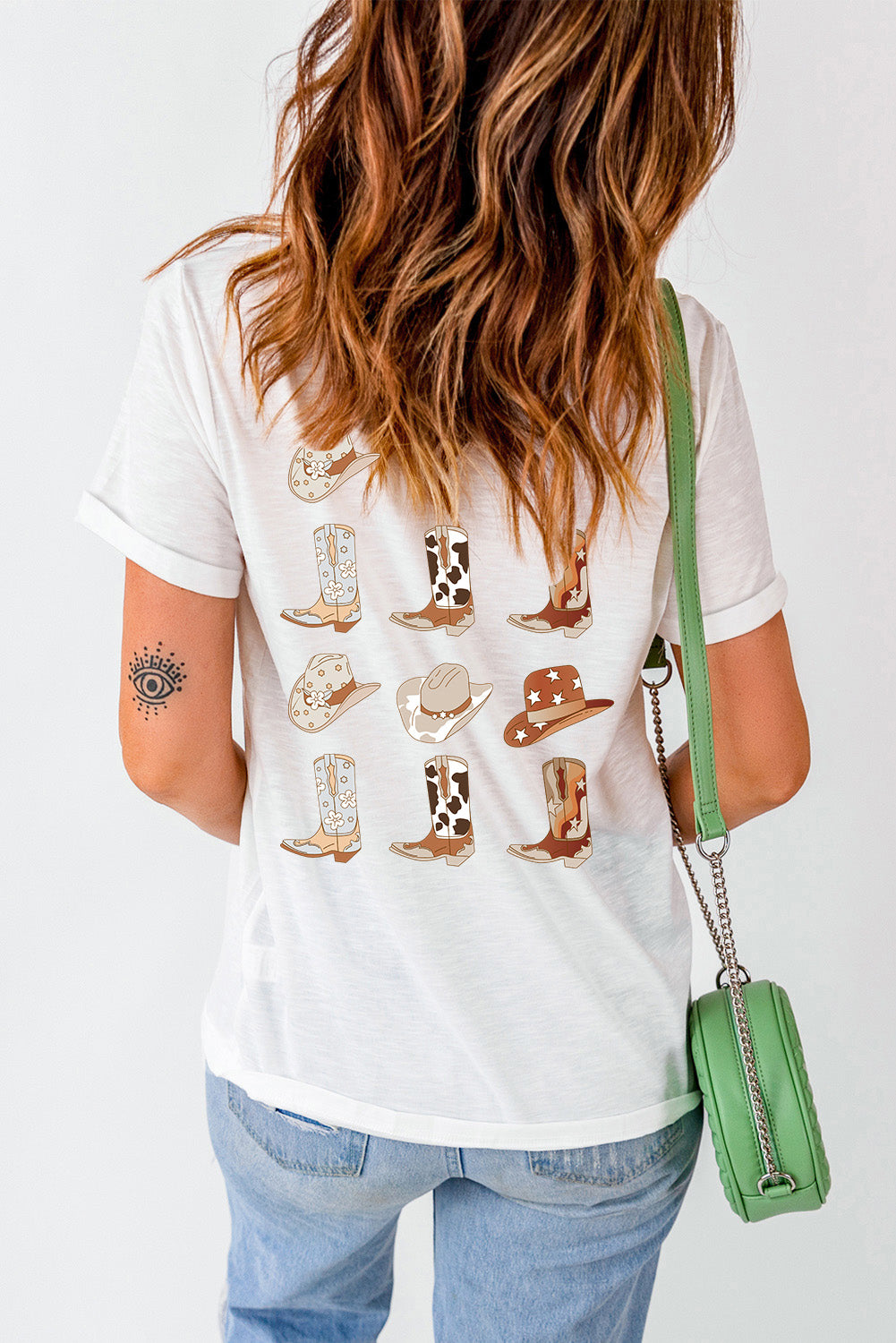 White graphic tee with cowboy boots and hats print, short sleeves, crew neck.