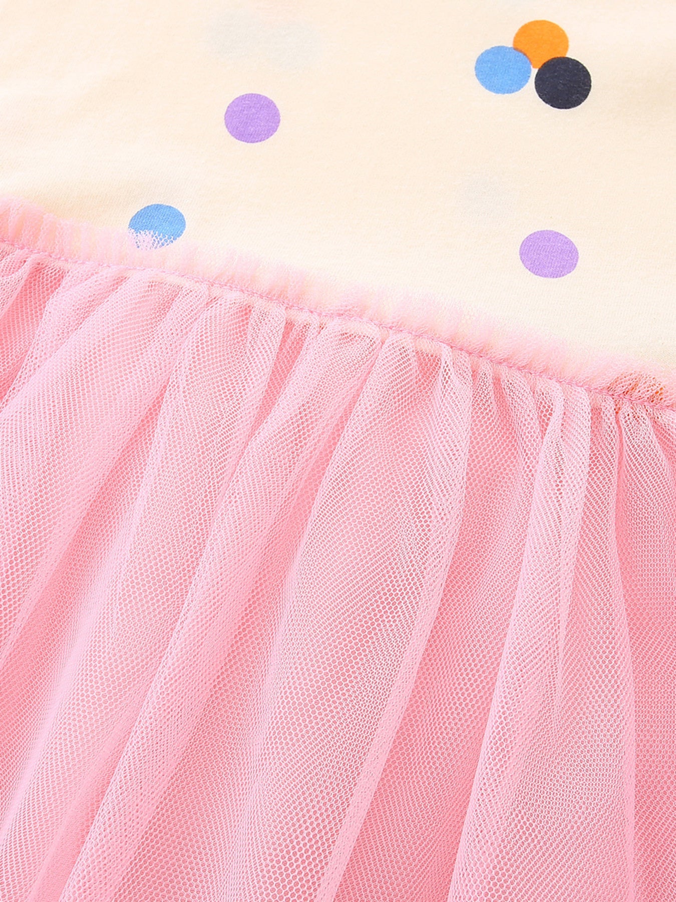 Toddler dress with playful polka dots and pink tulle skirt.
