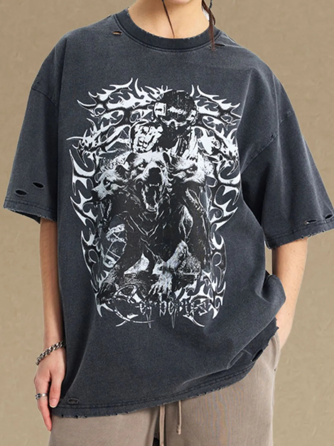 Black oversized graphic tee with distressed details and wolf artwork.