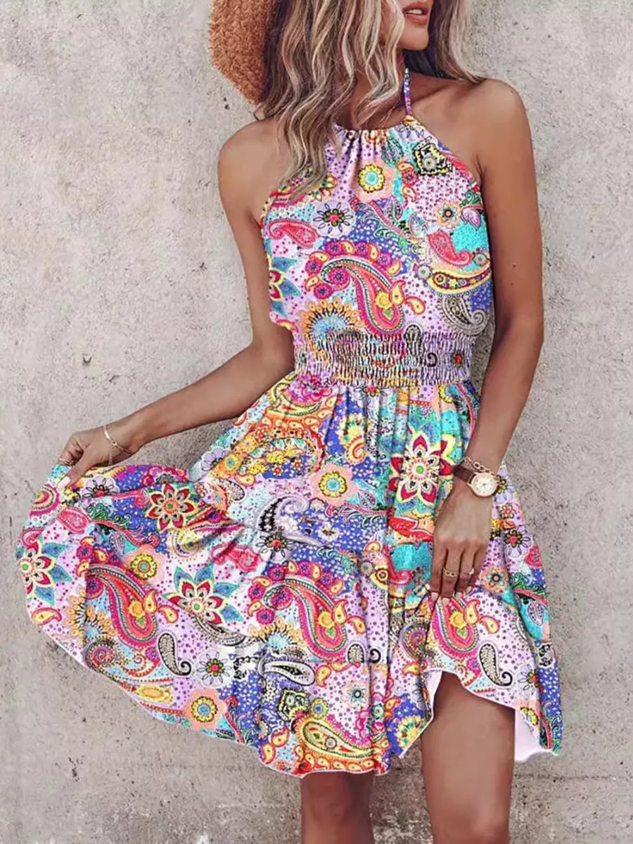 Bohemian halter mini dress with colorful paisley print and smocked waist.