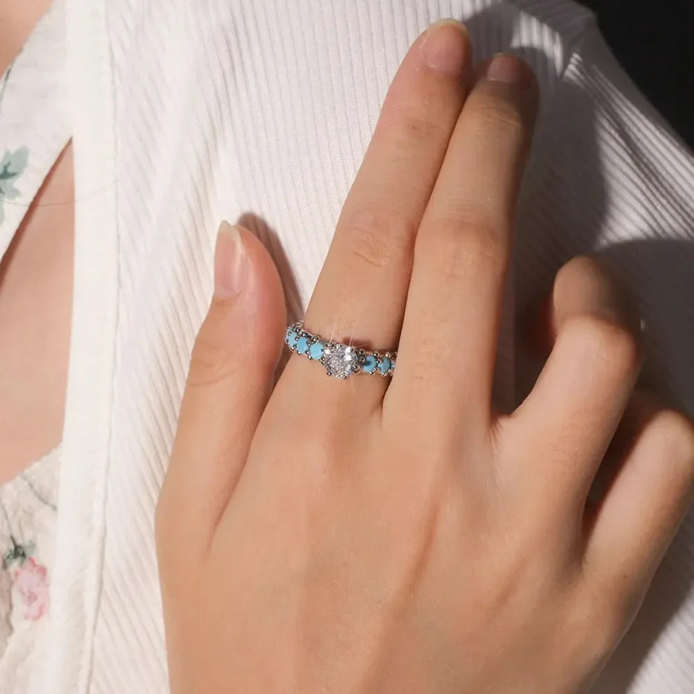 Silver ring with solitaire and turquoise bezel detail