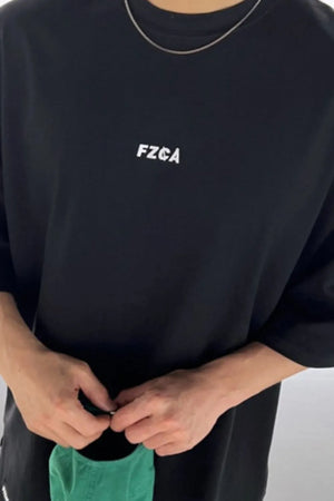 Black oversized tee with drop shoulder and white logo detail