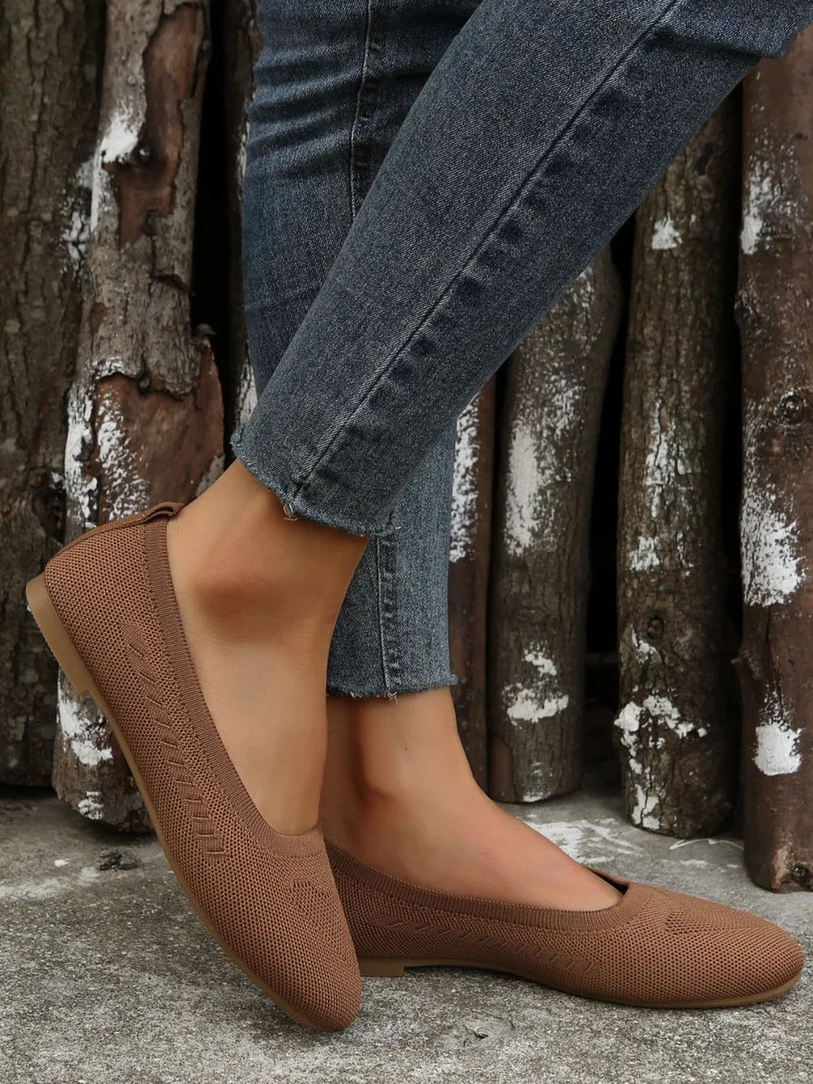 Beige knit ballet flats with subtle diamond pattern detail and flexible sole.