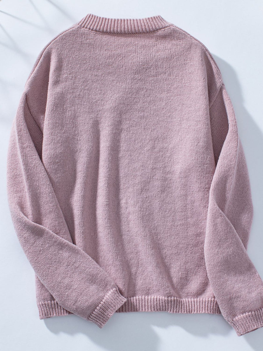 Dusty pink knit sweater with notched neckline and ribbed cuffs and hem.