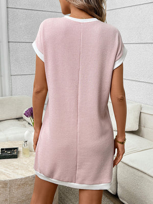 Pink ribbed knit mini dress with white trim and short sleeves.