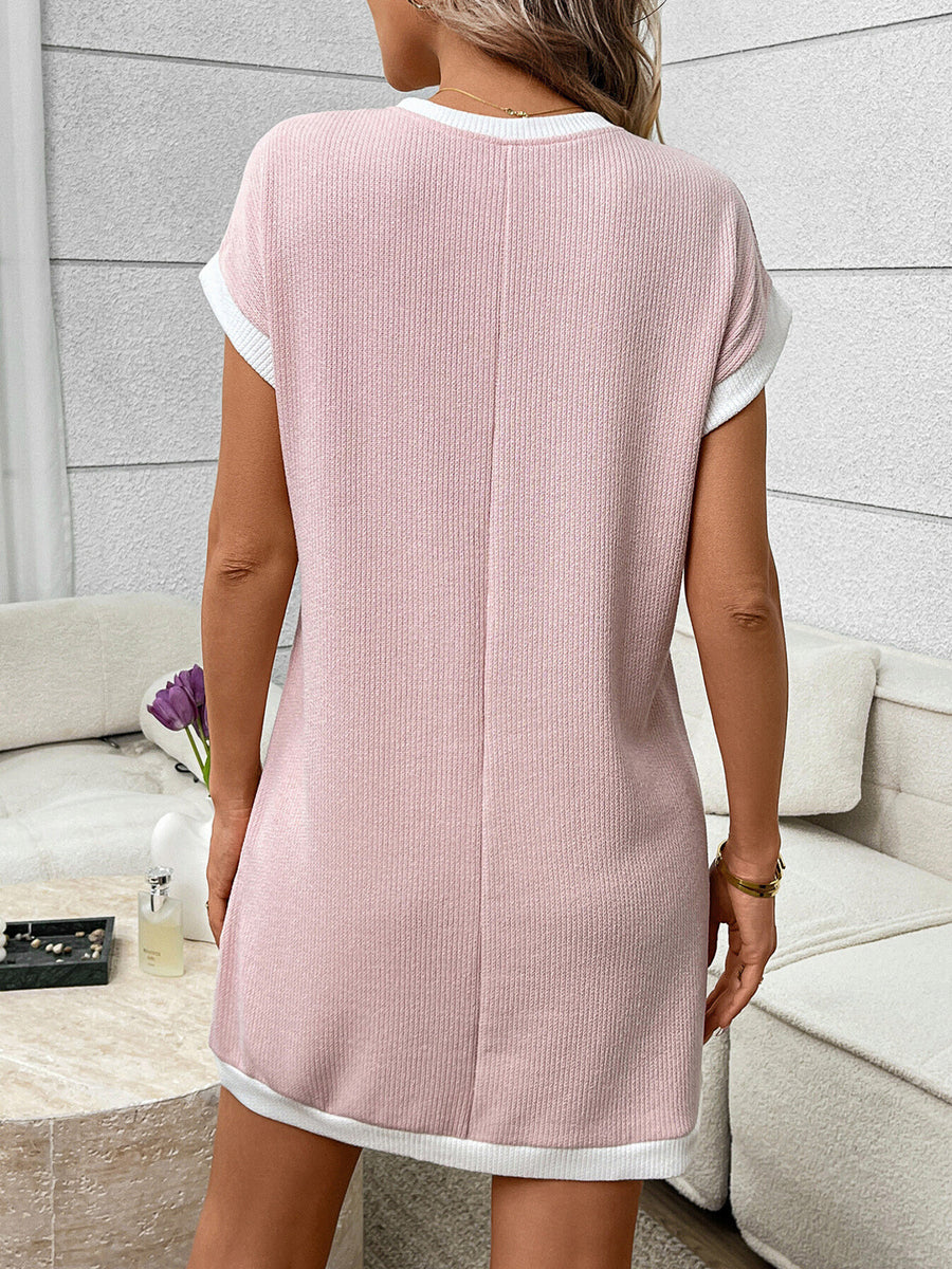 Pink ribbed knit mini dress with white trim and short sleeves.