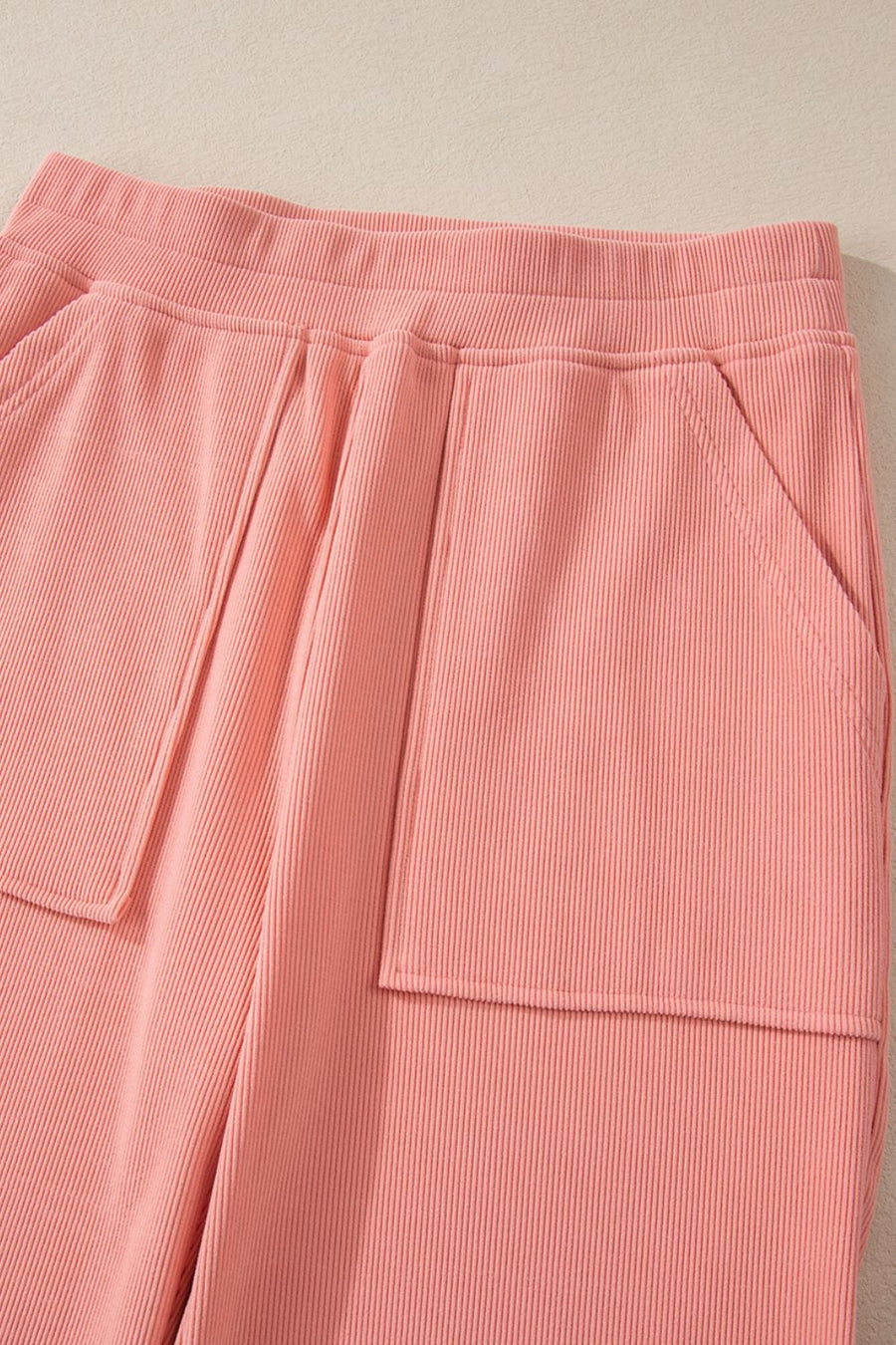 Pink ribbed pants with elastic waist and patch pockets