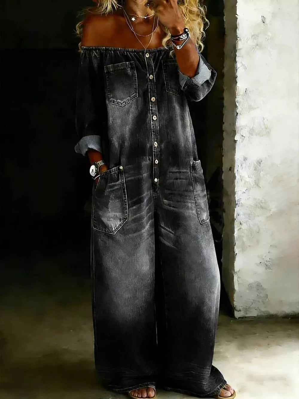 Gray off-shoulder denim jumpsuit with button-down front and large pockets.