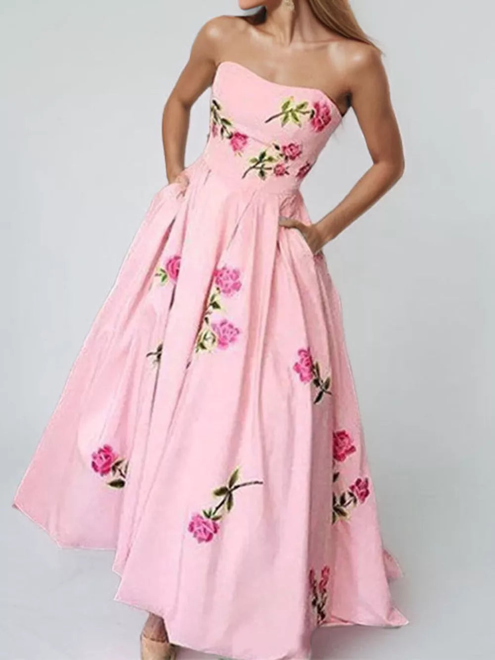 Blush pink floral print tube maxi dress with pockets and a full skirt.