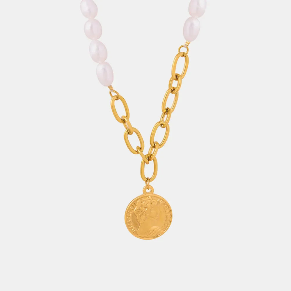 Gold pearl and coin link necklace with oval pearls and a coin pendant.