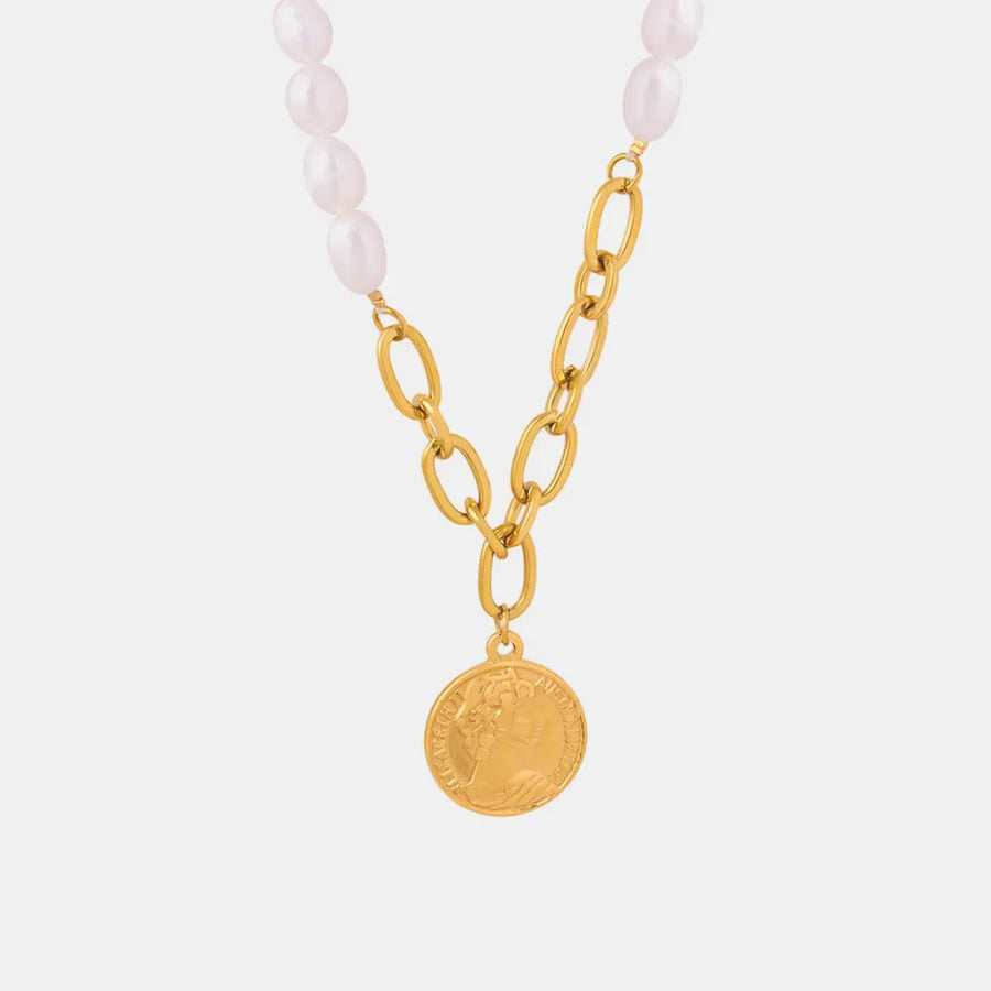 Gold pearl and coin link necklace with oval pearls and a coin pendant.