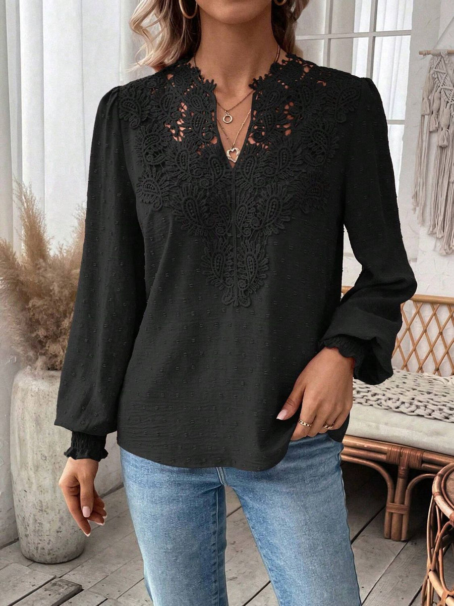 Black embroidered yoke blouse with puff sleeves and textured fabric