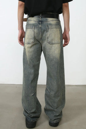 Faded wash baggy carpenter jeans in medium, featuring a distressed look and relaxed fit.