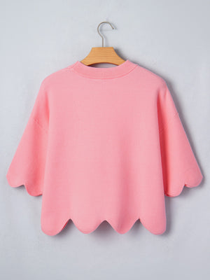 Pink knit sweater with scalloped hem and sleeves