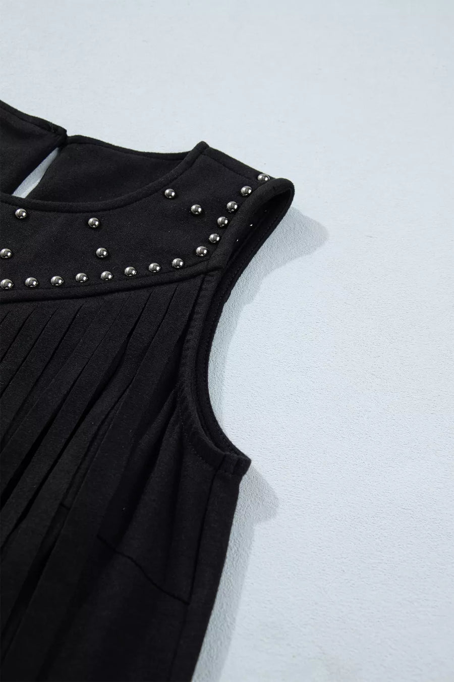 Black sleeveless tank top with rhinestone embellishments and fringe detail.