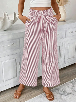 Maternity paper bag waist pants in dusty pink and white stripes with a tie belt.