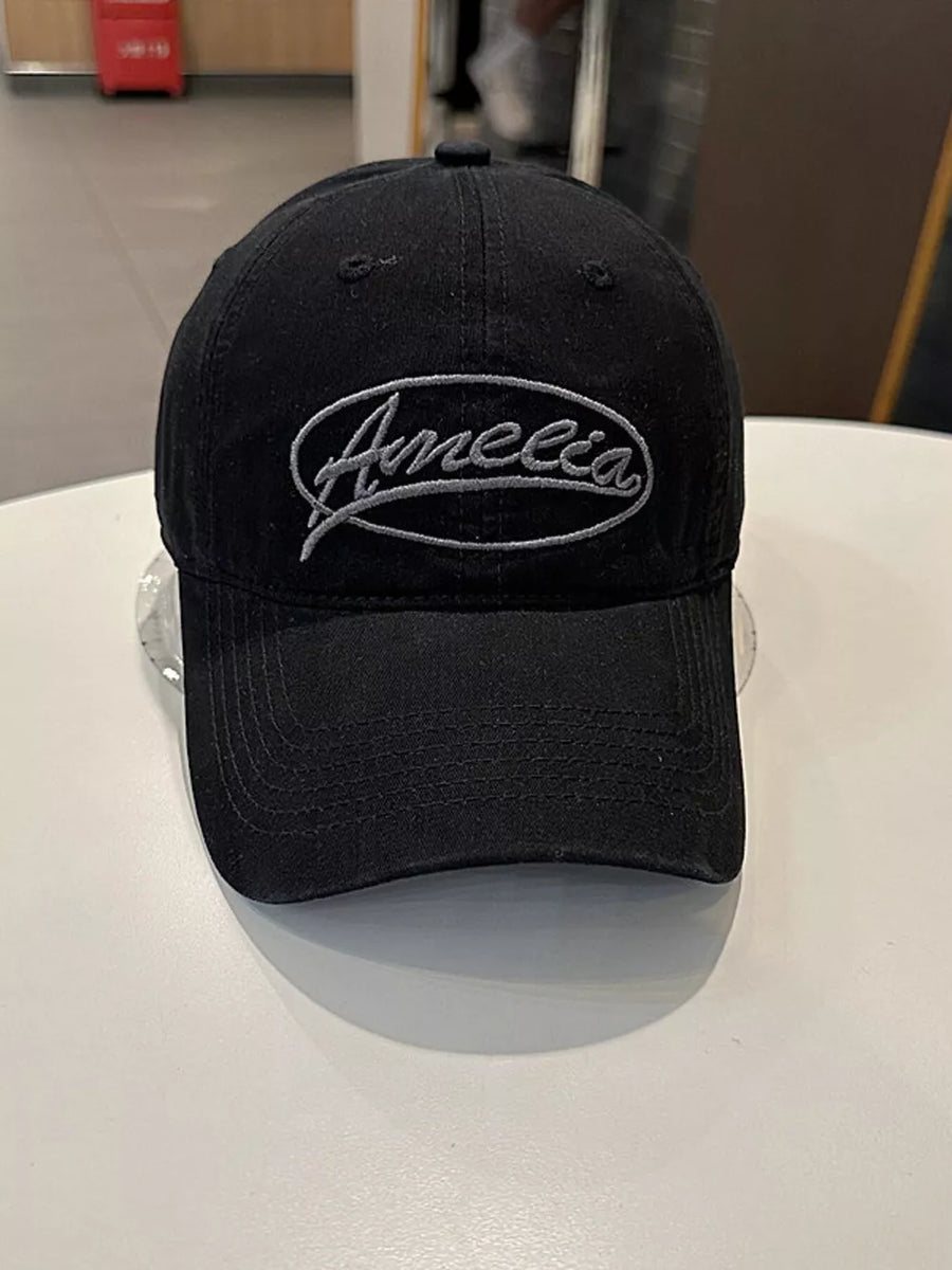 Black baseball cap with embroidered oval logo detail