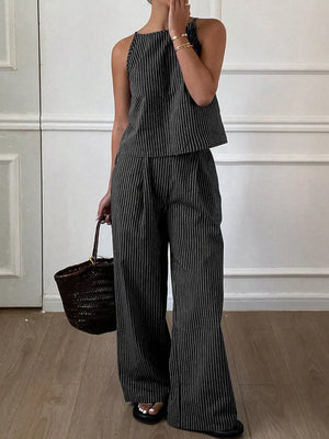 Black striped sleeveless top and wide-leg pants set with a halter neckline.