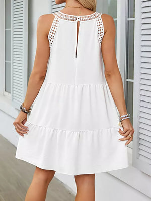 White tiered dress with lace neckline and back detail.