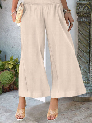 Smocked waist wide-leg pants in light brown with pockets, ankle-length, casual, comfortable.