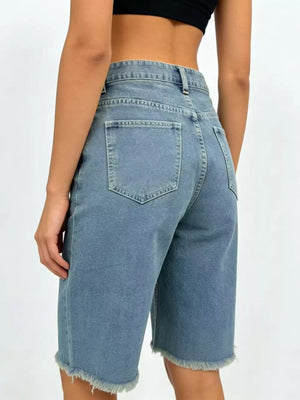Blue denim bermuda shorts with frayed hem and relaxed fit.