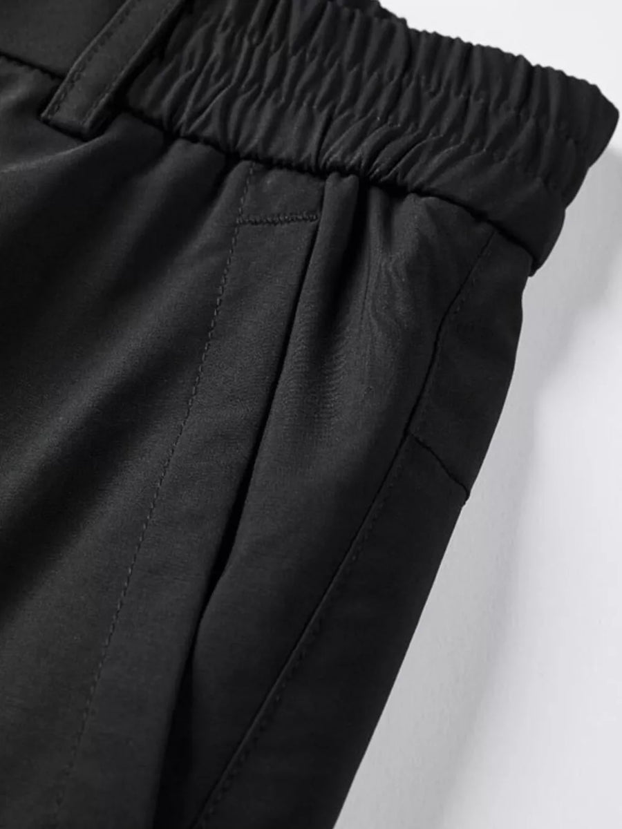 Black cargo pants with elastic waistband and side pockets.