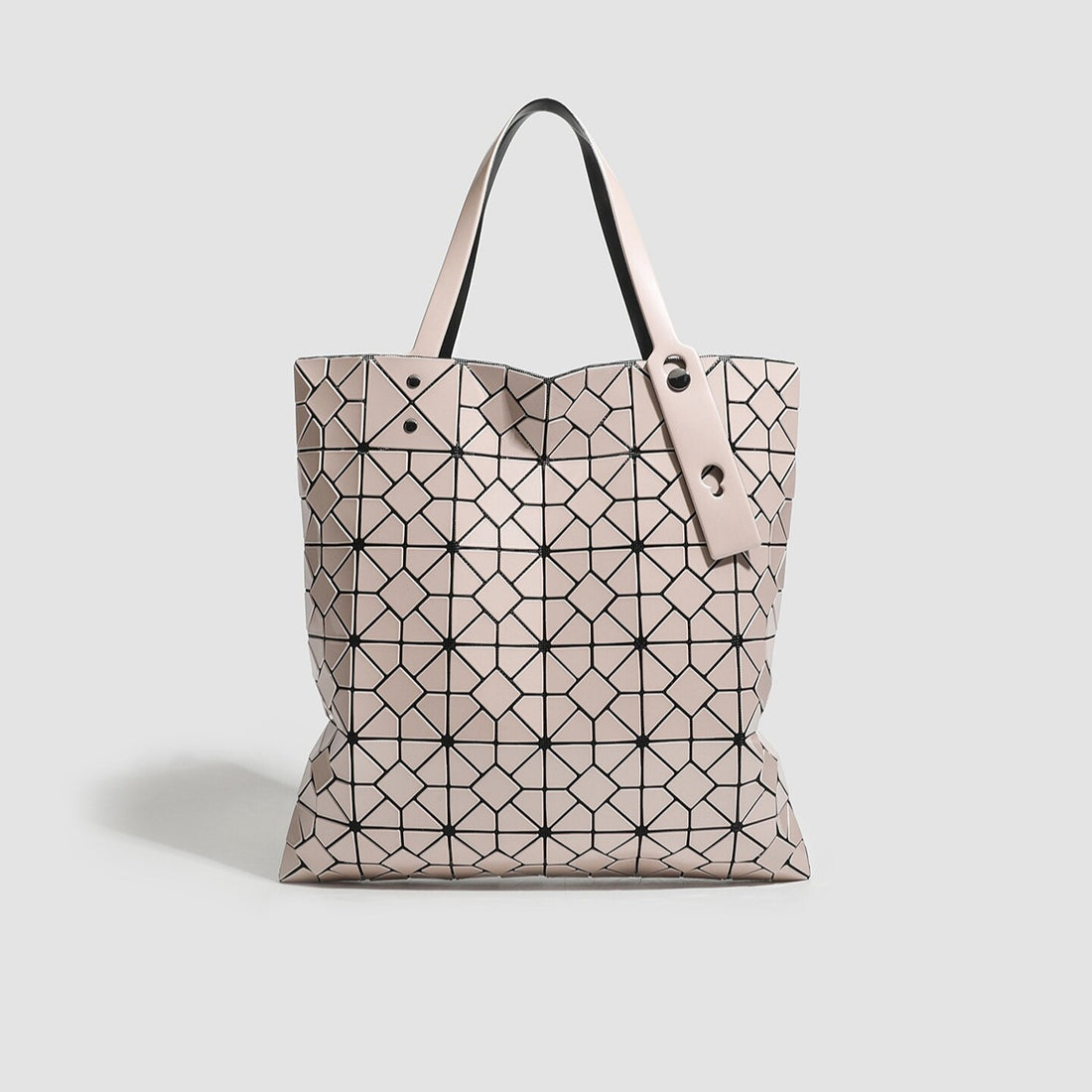 handbag in blush pink featuring geometric paneling and boxy fit