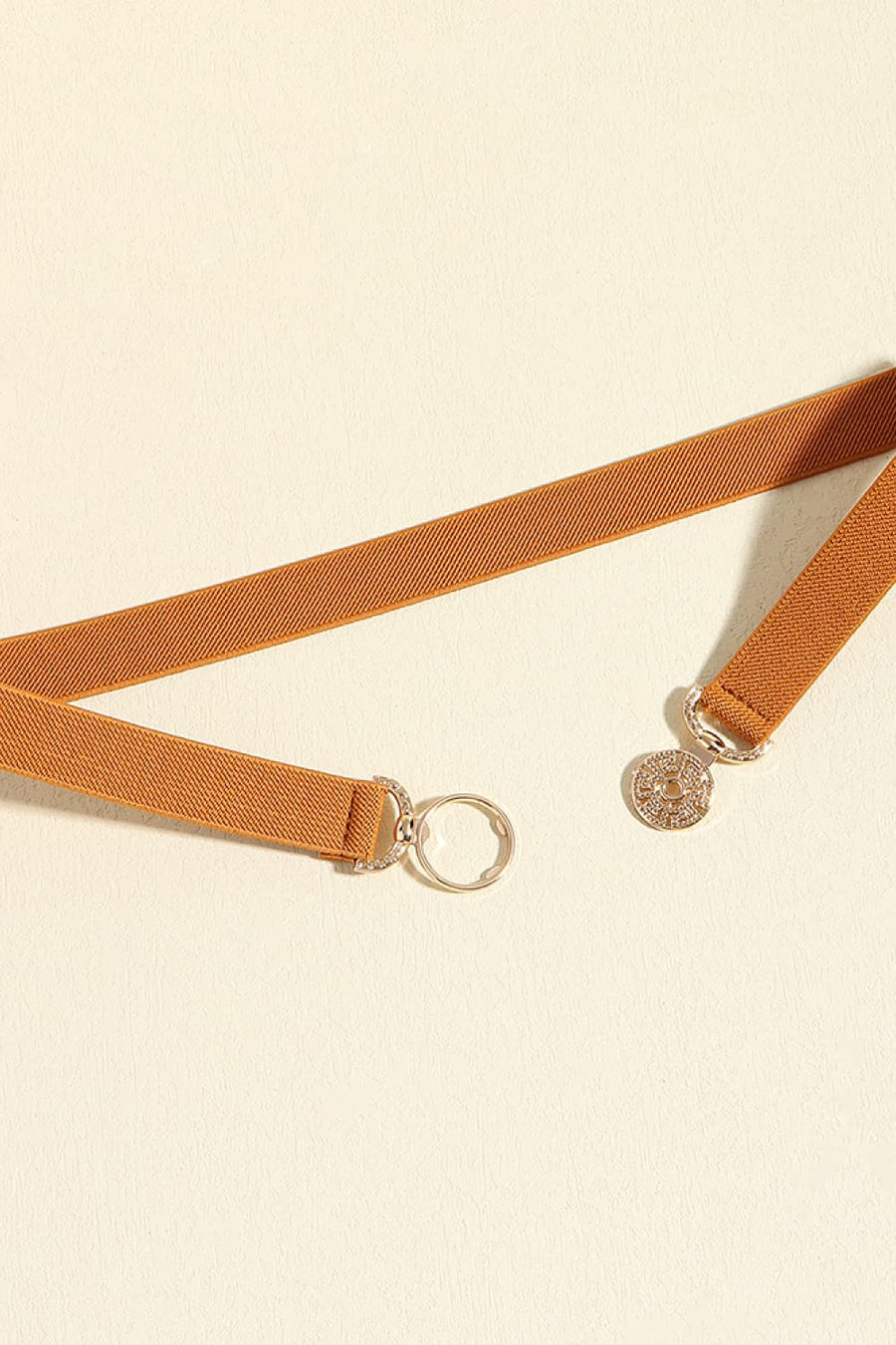 Caramel elasticated belt with medallion buckle and ring detail