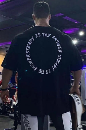 Black oversized t-shirt with white circle text graphic on back