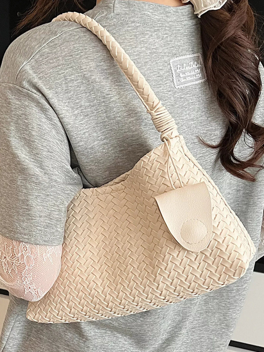 Off-white woven shoulder bag with braided strap and leather flap closure