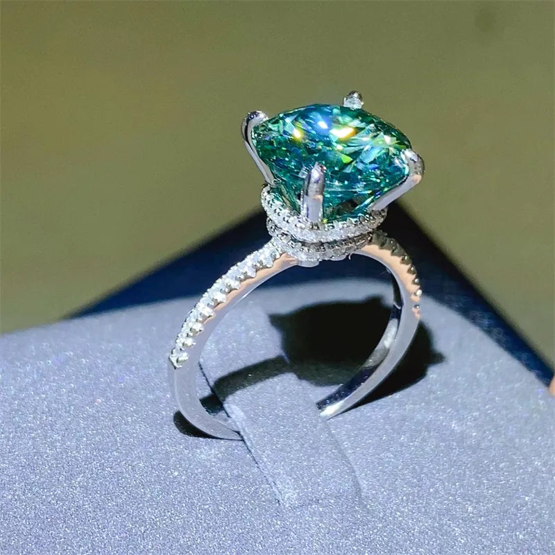 Radiant teal moissanite pavé ring in silver with a large center stone.