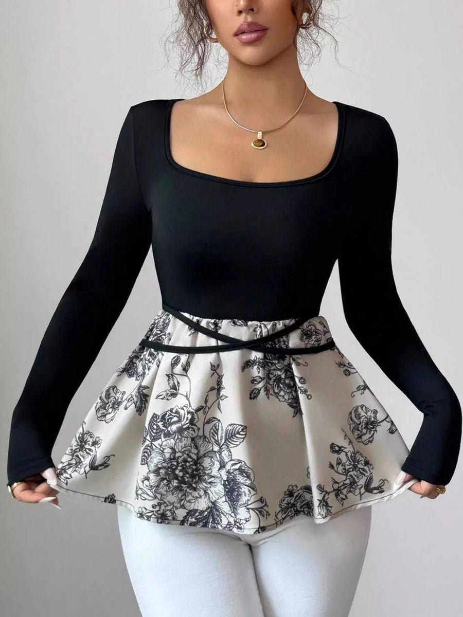Black long-sleeve top with a square neck and a peplum hem featuring a floral print.