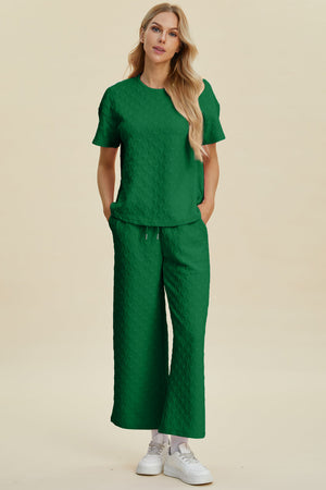 Textured knit lounge set in dark green with wide leg pants and short sleeve top.