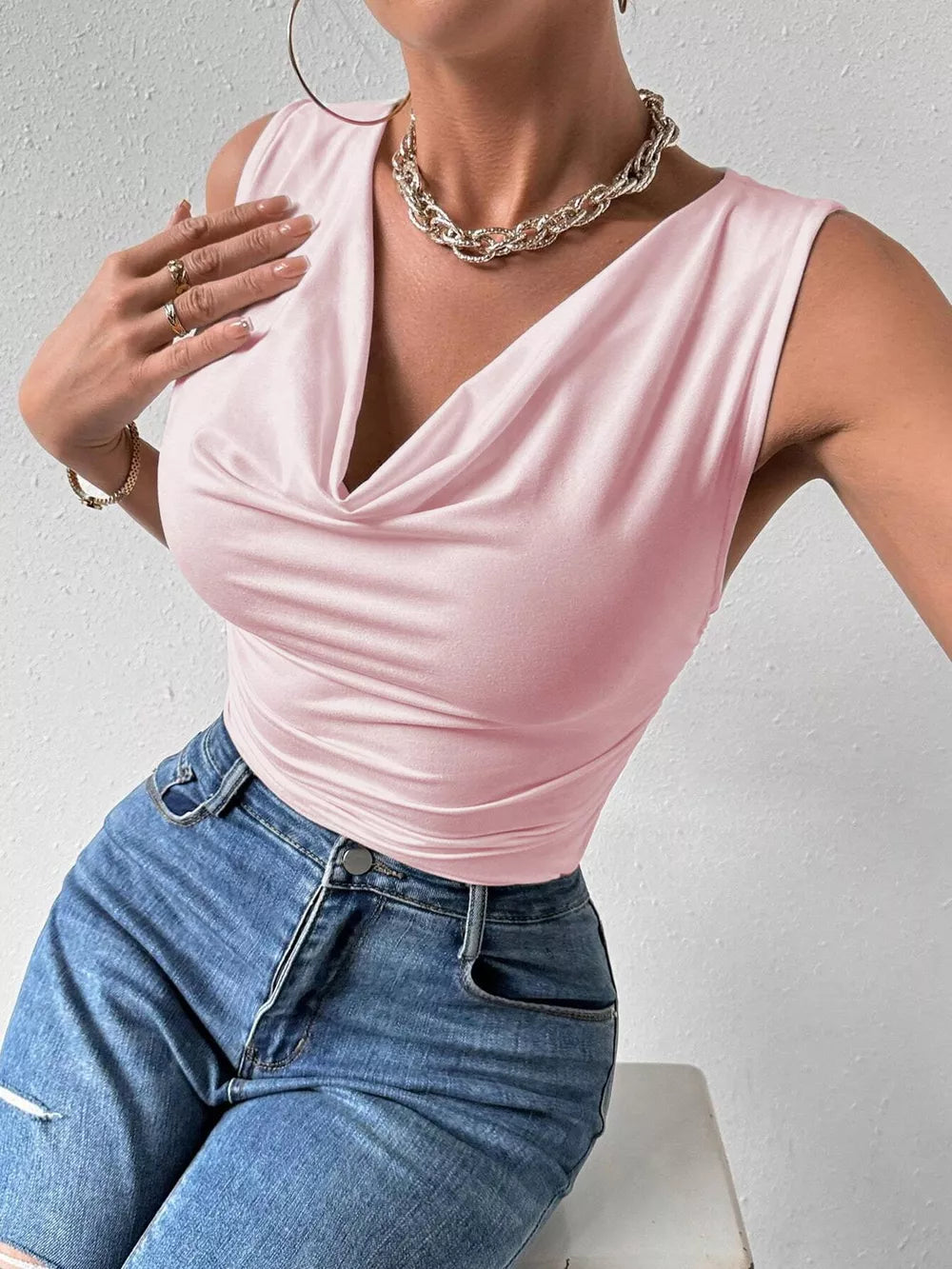 Pink ruched cowl neck tank top with draped neckline and sleeveless cut.