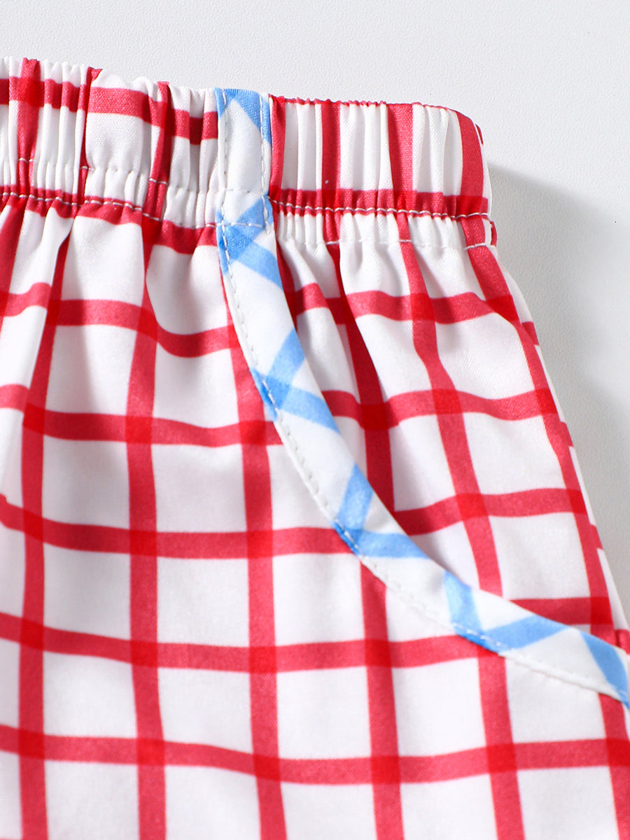 Baby shorts with red and white gingham pattern and blue trim detail