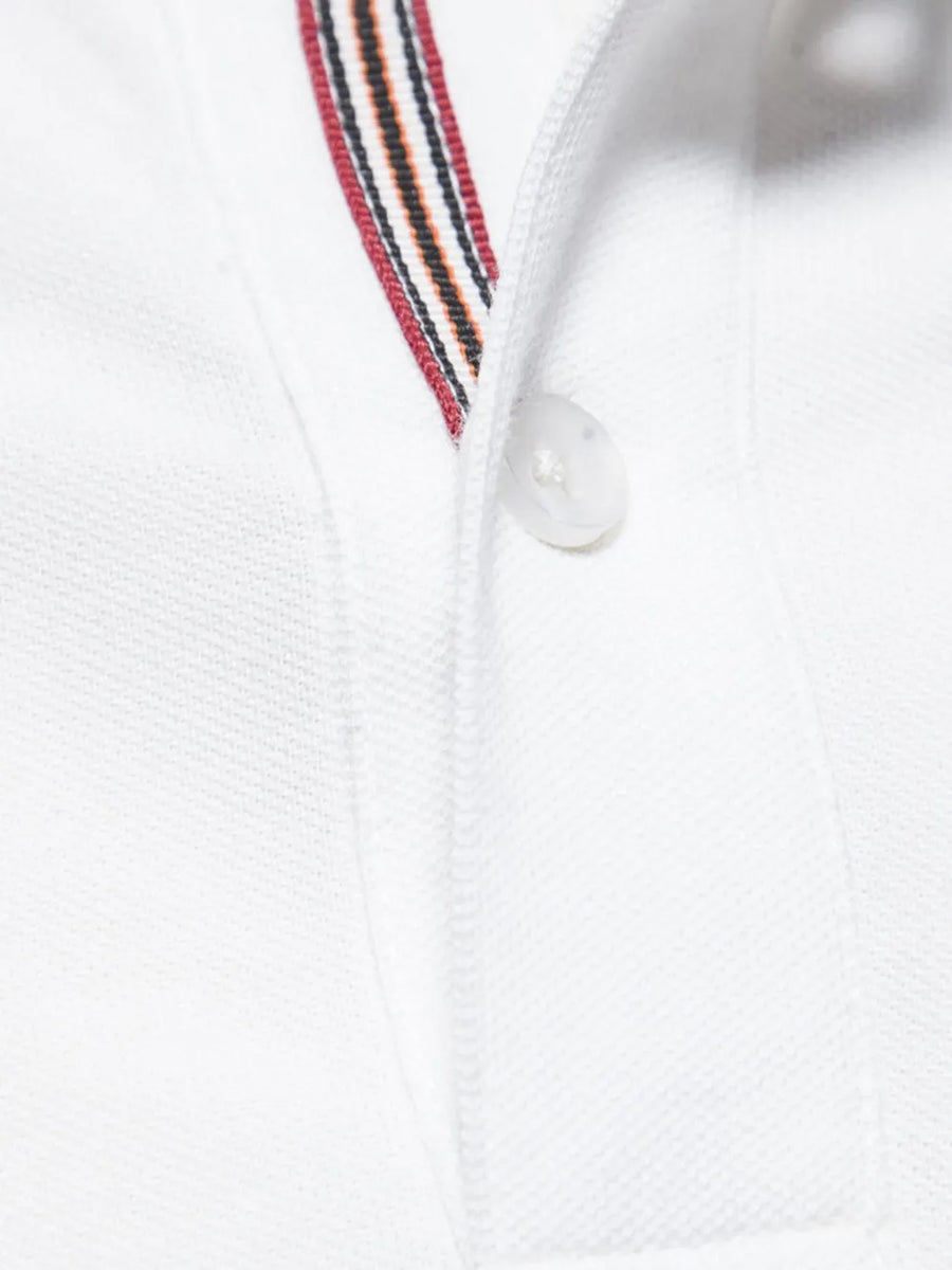 White piqué polo shirt with striped trim and button detail