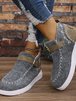Gray textured stitch-detail buckle sneakers with white contrast stitching and a brown strap detail.