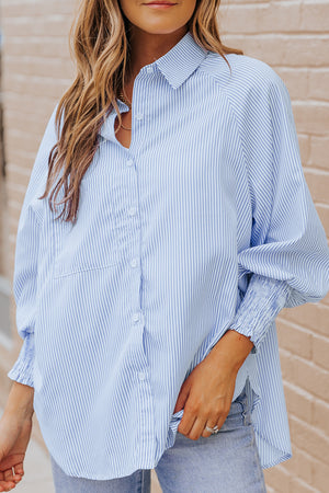 Pastel blue pinstripe blouse with balloon sleeves and smocked cuffs.