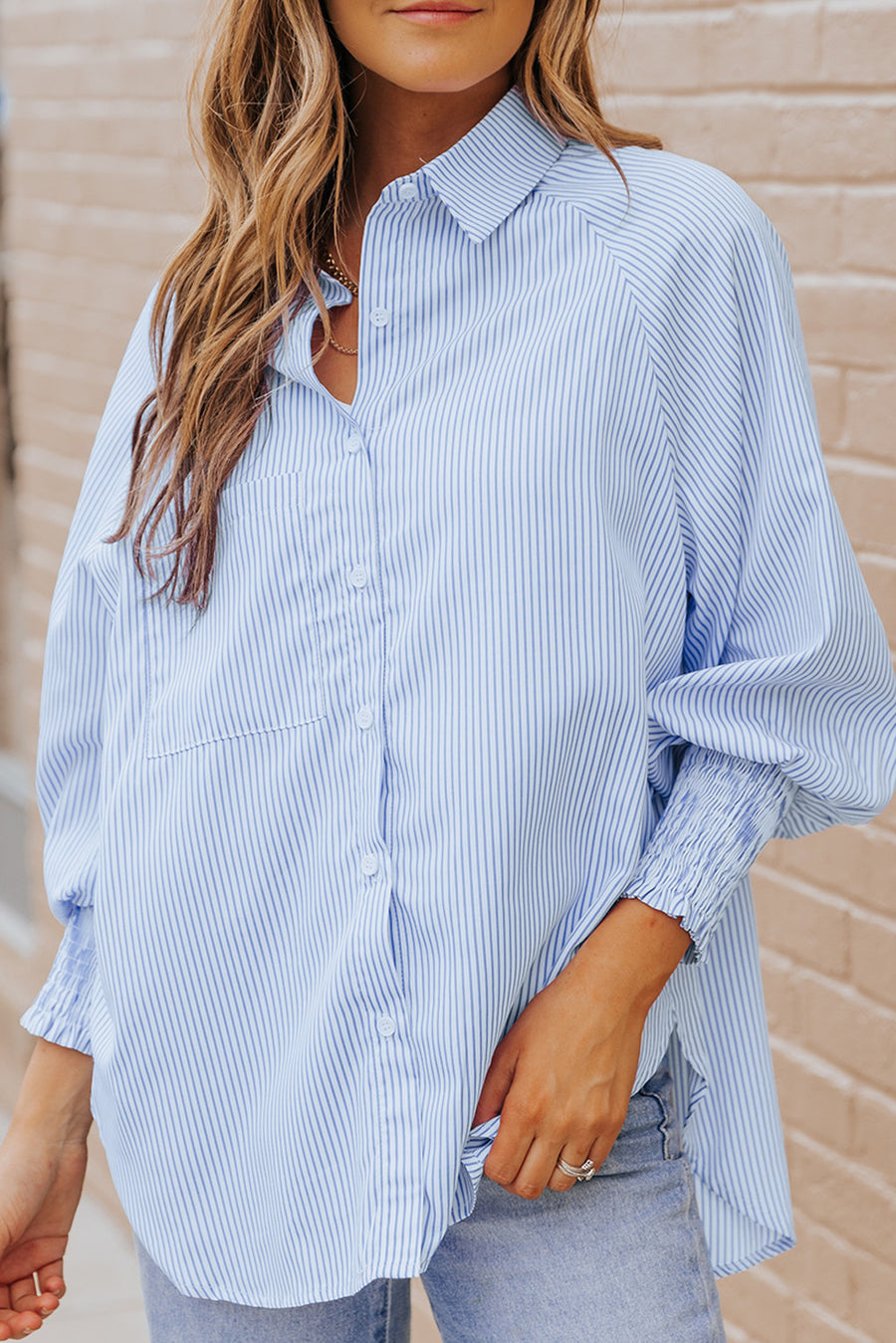 Pastel blue pinstripe blouse with balloon sleeves and smocked cuffs.