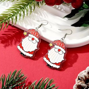 Red Santa Claus acrylic dangle earrings with star detail.