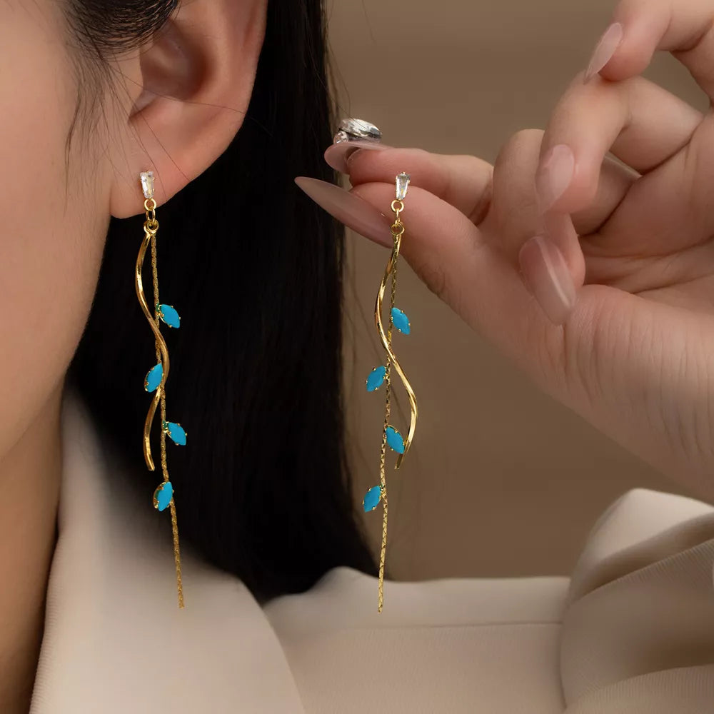 earrings in gold featuring drop design and elongated fit