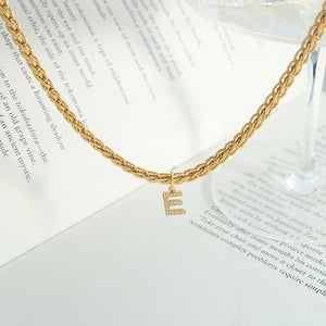 Gold chain necklace with a zircon-set initial E pendant